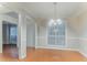 Open dining room with wood floors, updated lighting, and views into adjacent rooms at 2341 Alden, Jonesboro, GA 30236