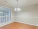 Inviting dining room with wood floors, updated lighting, and bright window views at 2341 Alden, Jonesboro, GA 30236