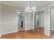 Open dining room with wood floors, updated lighting, and views into the kitchen and bathroom at 2341 Alden, Jonesboro, GA 30236