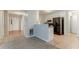 Open floor plan with a view into the kitchen featuring white cabinets and black appliances at 2341 Alden, Jonesboro, GA 30236