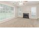Spacious living room with large windows, a fireplace, and neutral carpet at 2341 Alden, Jonesboro, GA 30236
