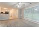 Living room with large windows, carpet, and a view of the kitchen at 2341 Alden, Jonesboro, GA 30236