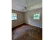 Bedroom featuring hardwood floors, dual windows for natural light, and neutral-colored walls at 3130 Gay Dr, Decatur, GA 30032