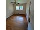 Bedroom featuring hardwood floors, dual windows for natural light, and neutral-colored walls at 3130 Gay Dr, Decatur, GA 30032