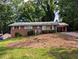 Charming brick home with a single-story layout and a cozy carport, nestled on a hill with mature trees at 3130 Gay Dr, Decatur, GA 30032