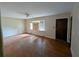 Spacious living room featuring hardwood floors, natural light from the window, and neutral-colored walls at 3130 Gay Dr, Decatur, GA 30032