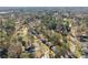 This aerial view showcases a quiet neighborhood surrounded by mature trees and winding roads at 4076 Shady Nw Cir, Lilburn, GA 30047