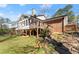 View of the brick home's backyard featuring the stairs leading to the deck and screened-in porch at 4076 Shady Nw Cir, Lilburn, GA 30047