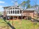 Backyard view showcasing the raised screened-in porch with a deck and lower-level access at 4076 Shady Nw Cir, Lilburn, GA 30047