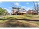 View of the backyard and back exterior of the home, featuring a large screened-in porch at 4076 Shady Nw Cir, Lilburn, GA 30047