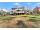 Home's backyard featuring the screened-in porch and deck in a grassy setting at 4076 Shady Nw Cir, Lilburn, GA 30047