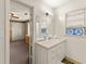 Bathroom featuring a vanity, sink, mirror, with an adjacent room view at 4076 Shady Nw Cir, Lilburn, GA 30047
