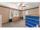 Cozy bedroom with a window view, wood dresser, neutral carpet, bunk bed and ceiling fan at 4076 Shady Nw Cir, Lilburn, GA 30047
