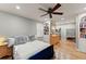 Bright bedroom featuring hardwood floors, a ceiling fan, built-in shelving, and natural light at 4076 Shady Nw Cir, Lilburn, GA 30047