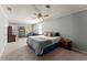 Cozy carpeted bedroom featuring a ceiling fan, a desk, and natural light at 4076 Shady Nw Cir, Lilburn, GA 30047