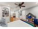 Cozy bedroom featuring hardwood floors, built-in shelving, a ceiling fan, and a variety of decor at 4076 Shady Nw Cir, Lilburn, GA 30047