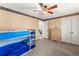 Spacious bedroom with a blue bunk bed, wood dresser, neutral carpet and ceiling fan at 4076 Shady Nw Cir, Lilburn, GA 30047