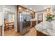 Updated kitchen with stainless steel refrigerator, granite counters, and wood cabinets at 4076 Shady Nw Cir, Lilburn, GA 30047