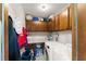 Well-organized laundry room with washer, dryer, cabinets, countertop, and storage at 4076 Shady Nw Cir, Lilburn, GA 30047
