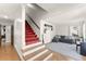 Cozy living room featuring a staircase, hardwood floors, and comfortable seating at 4076 Shady Nw Cir, Lilburn, GA 30047