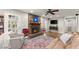 Cozy living room with brick fireplace, hardwood floors, and comfortable seating at 4076 Shady Nw Cir, Lilburn, GA 30047