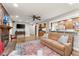 Bright open living room featuring a brick fireplace and access to kitchen at 4076 Shady Nw Cir, Lilburn, GA 30047