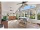 Bright sunroom featuring a vaulted ceiling, a variety of windows, and hardwood floors at 4076 Shady Nw Cir, Lilburn, GA 30047