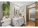 Cozy half-bathroom with modern fixtures, wood accents, stylish mirror, and decorative greenery at 4343 Sprucebough Dr, Marietta, GA 30062