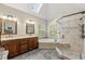 Spacious primary bathroom with a soaking tub, frameless shower, dual vanities, and skylight at 4343 Sprucebough Dr, Marietta, GA 30062