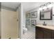 Neutral bathroom featuring a walk-in shower, vanity, and framed artwork at 4343 Sprucebough Dr, Marietta, GA 30062