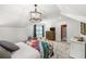 Bright bedroom with a decorative chandelier, sloped ceilings, and colorful bedding for an inviting space at 4343 Sprucebough Dr, Marietta, GA 30062