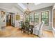 Bright dining room featuring hardwood floors, skylights, and large windows overlooking the property's backyard at 4343 Sprucebough Dr, Marietta, GA 30062