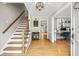 Inviting foyer with hardwood floors, a staircase, and access to a home office at 4343 Sprucebough Dr, Marietta, GA 30062
