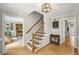 Open foyer featuring hardwood floors, a staircase, and a view into the dining room at 4343 Sprucebough Dr, Marietta, GA 30062