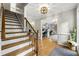 Welcoming foyer with hardwood floors, a staircase, and a glimpse of the home office at 4343 Sprucebough Dr, Marietta, GA 30062