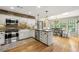 Bright kitchen featuring white cabinets, stainless steel appliances, and an adjacent dining area at 4343 Sprucebough Dr, Marietta, GA 30062