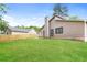 Well-manicured backyard with lush green grass, a partial fence, and the home's exterior at 8455 Cedar Creek Rdg, Riverdale, GA 30274