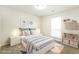 This virtually staged bedroom features shelving, a window, and a neutral color palette at 8455 Cedar Creek Rdg, Riverdale, GA 30274