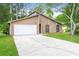 View of home featuring an attached garage and a well-manicured lawn at 8455 Cedar Creek Rdg, Riverdale, GA 30274