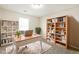 This virtually staged home office features built-in bookshelves, a bright window, and stylish decor at 8455 Cedar Creek Rdg, Riverdale, GA 30274