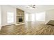 Bright living room featuring hardwood floors and a stone fireplace at 8455 Cedar Creek Rdg, Riverdale, GA 30274