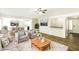 A beautifully staged living room featuring hardwood floors and an open layout to the kitchen at 8455 Cedar Creek Rdg, Riverdale, GA 30274