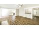Open living room showcasing hardwood floors and an open layout to the kitchen at 8455 Cedar Creek Rdg, Riverdale, GA 30274