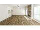 Spacious living room with hardwood floors and a stone fireplace feature at 8455 Cedar Creek Rdg, Riverdale, GA 30274