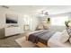 A virtually staged main bedroom features a ceiling fan, gray carpet, and an adjacent bathroom with vanity at 8455 Cedar Creek Rdg, Riverdale, GA 30274