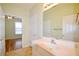Bathroom with a white vanity, faucet, and a large mirror over the vanity at 179 Camry Ln, Grayson, GA 30017