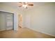 Bedroom featuring a closet with shelving, ceiling fan, and a bathroom view at 179 Camry Ln, Grayson, GA 30017