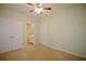 Bedroom with a ceiling fan and carpet, featuring a view into the bathroom at 179 Camry Ln, Grayson, GA 30017