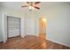 Bedroom featuring wood flooring, a ceiling fan, and closet with shelving at 179 Camry Ln, Grayson, GA 30017