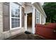 Home entryway showcases charming brick, wood siding, shutters and inviting door at 179 Camry Ln, Grayson, GA 30017